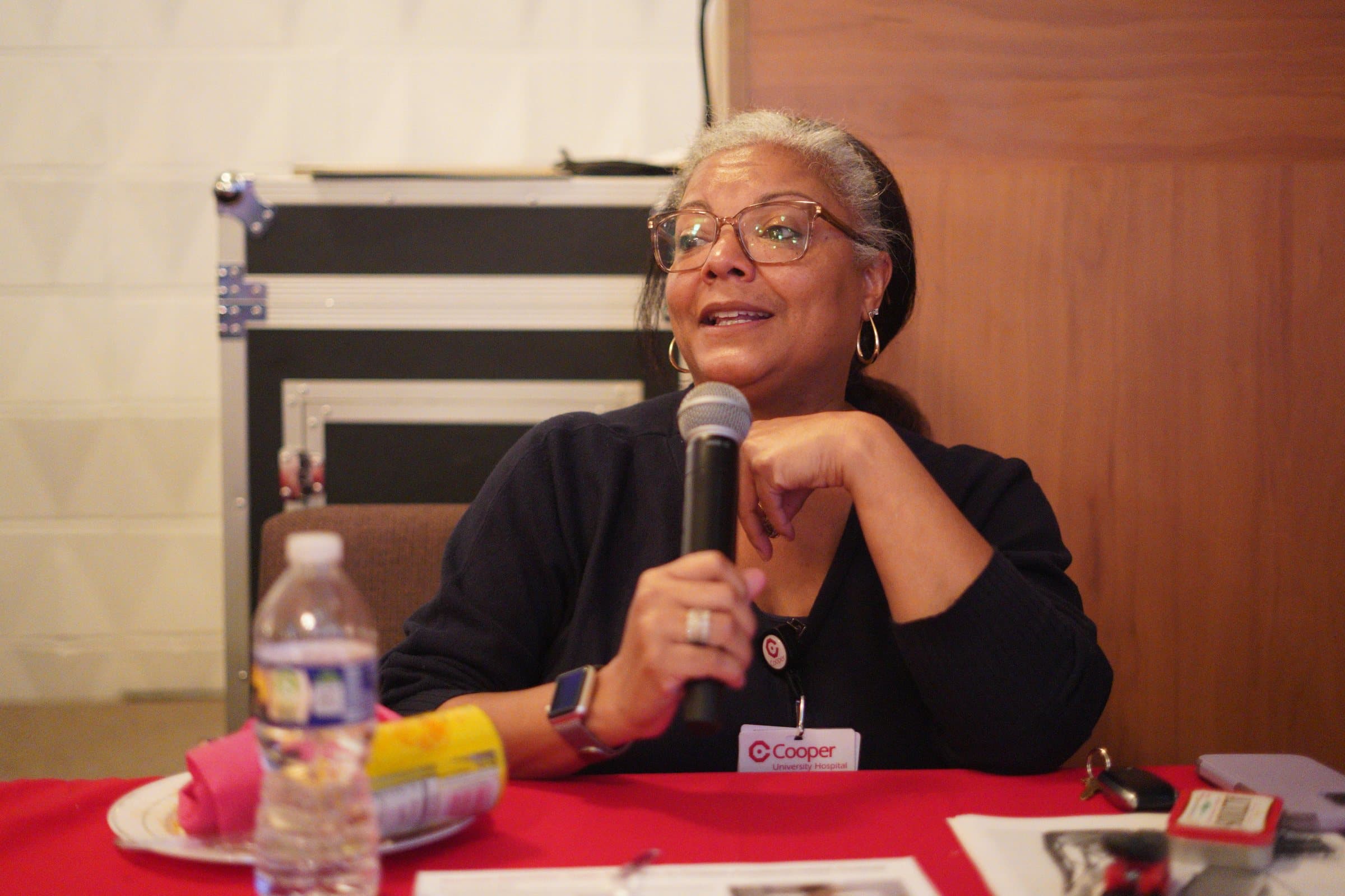 Speaker holding a microphone during A Date With Sis 2025