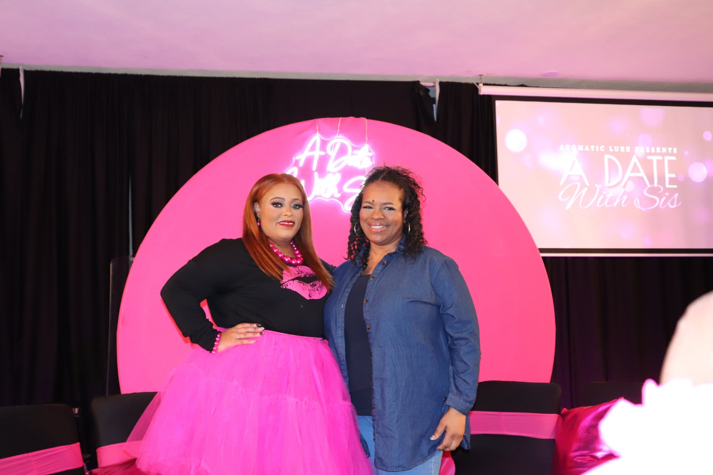 Women posing together at the A Date With Sis backdrop