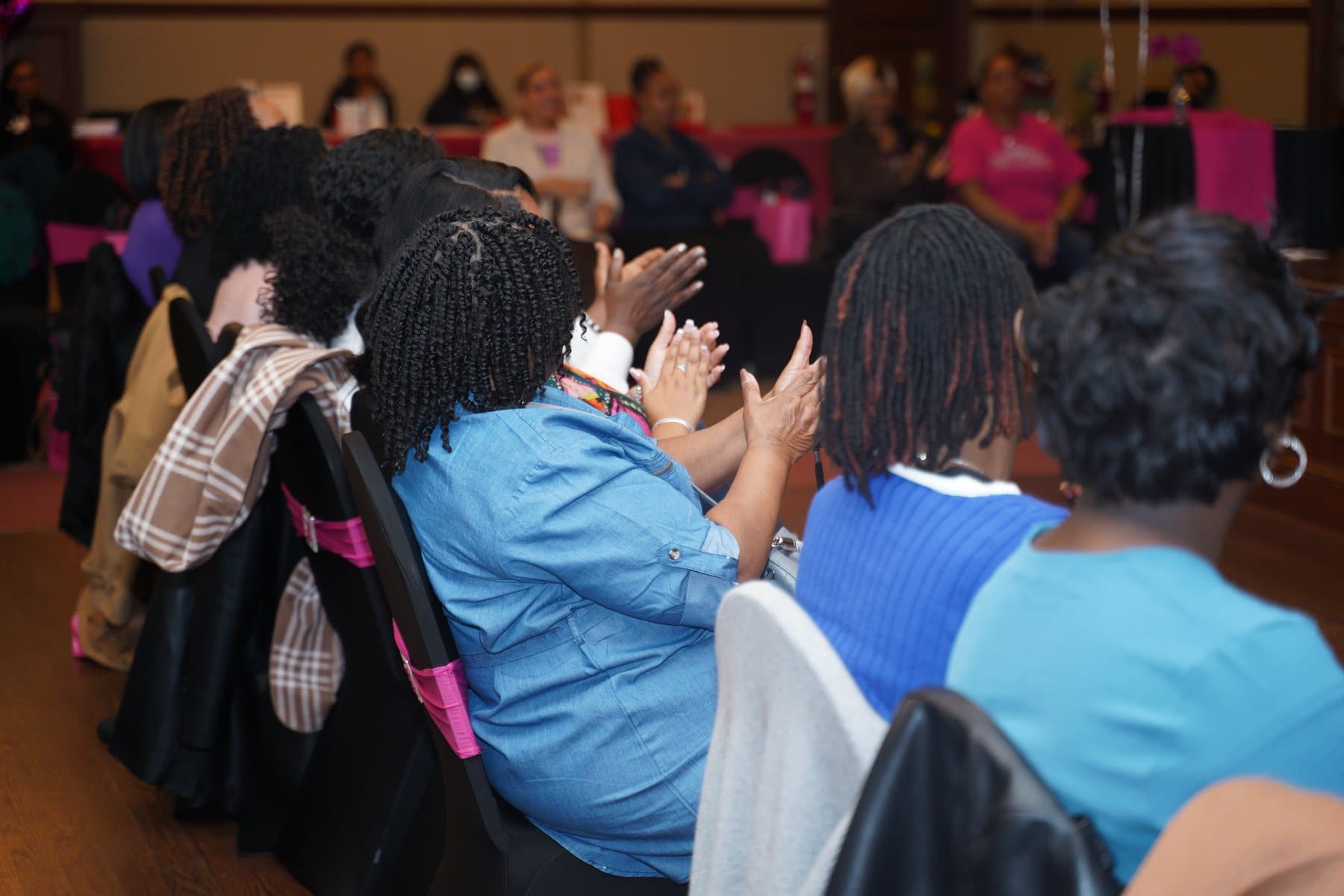 Audience members watching the panel
